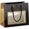 Bolsa papel cobre/negro impresin UV ventana PET asas cordn ojal 